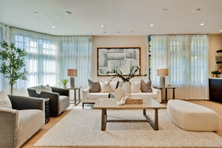Modern living room with gray sofa, white armchair, and coffee table.