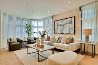 Modern living room with beige sofa, armchair, and coffee table.