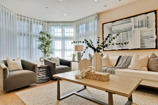 Modern living room with a beige sofa, armchair, and wooden coffee table.