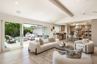 Living room With their open layouts, high ceilings, and urban feel, they require a design approach that defines spaces while maintaining flow