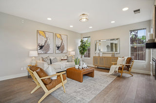 Living room with a couch, chairs, coffee table, and decorative elements.