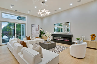 Modern bedroom with a bed, nightstands, and artwork on a white wall.