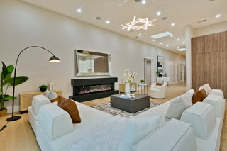 Modern living room with white sofa, coffee table, and decorative items.