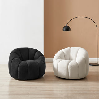 Black and cream boucle lounge chairs in modern interior setting.