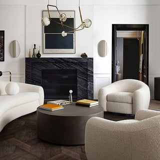 Modern Living Room with Curved Cream Seating and Black Marble Fireplace
