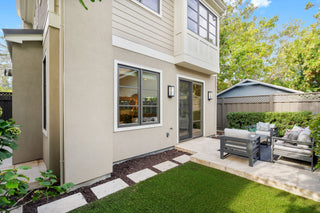 Modern house exterior with a patio area and outdoor furniture