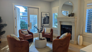 Modern beddroom with and bed, nightstands, and artworks non a white wall.