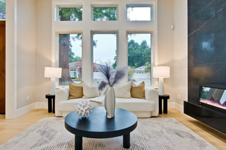 Modern bedroom with two beds, decorative pillows, and a side table.