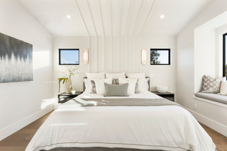 Modern bedroom with a bed, nightstands, and wall art