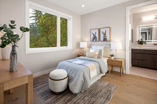 Modern bedroom with a bed, and cute winods ,nightstands, and decor elements.