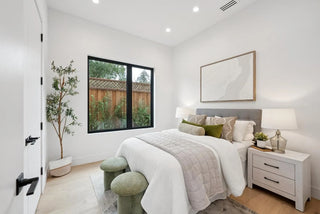 Modern bedroom with a bed, nightstands, and a large cute glass window.