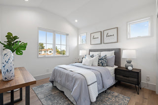 Modern bedroom with a bed, nightstands, and decorative elements.