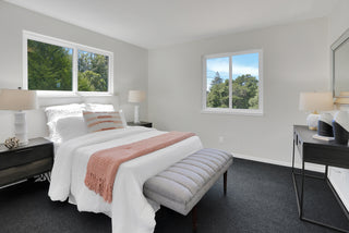 Modern bedroom with a bed, nightstands, and lamps with two glass windows
