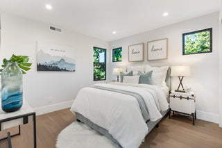 Modern bedroom with a bed, nightstands, and wall art