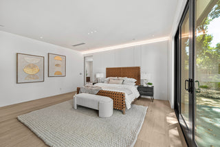 Modern bedroom with a bed, rug, and large door and outdoor design