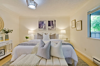 Neatly arranged bedroom with a bed, bench, and decor elements.