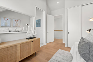 Modern bedroom with wooden sideboard, bed, and decor