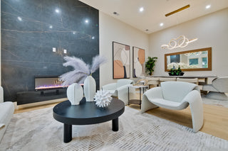Modern bedroom with two beds, decorative pillows, and a side table.