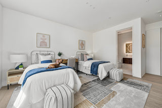 Modern bedroom with two beds, nightstands, and inner bathroom design