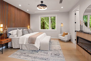 Modern bedroom with wooden headboard, bed, and decor.