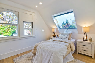 Modern bedrooms with large windows, bed, and outdoor view.
