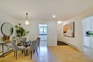 Modern dining room with a table, chairs, and decorative elements.