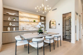 Modern dining room with a table and chairs in a stylishly decorated space.