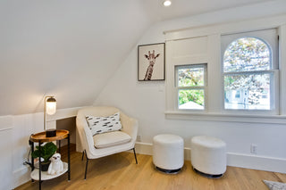 Modern dining room with a long table, chairs, and decorative elements.
