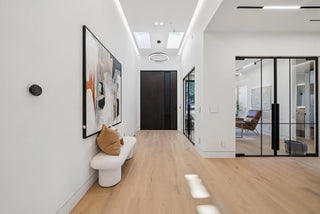 Modern hallway with a bench, artwork, and glass door wall printing