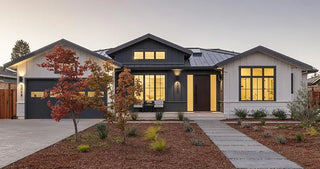 Modern house exterior with well-maintained garden and evening lights and skylight