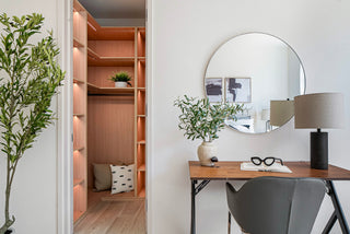 Modern interior with a desk, chair, mirror, and shelves. nice circle mirror and small sunglass