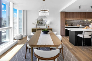 Modern kitchen and dining area with large windows and a stylish table.