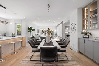 Modern kitchen and dining area with a long table and chairs.