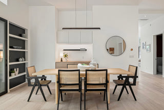 Modern kitchen and dining area with a wooden table and simple chairs.