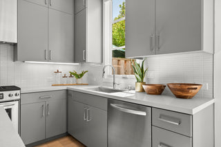 Modern kitchen with gray cabinets, white countertops, and stainless steel appliances