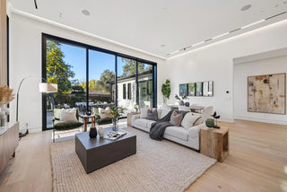 Modern living room and decorative items with large windows, white sofa, 