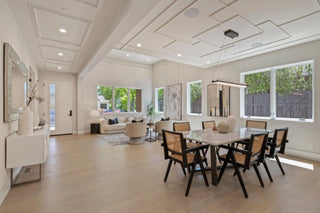 Modern living room , and dining view with white sofa, armchair, and marble coffee table. whtie interior