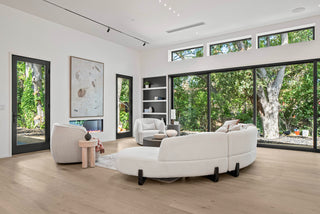 Modern living room and kitchen with white sofas and armchairs, marble fireplace, Soft  creates a cozy ambiance.