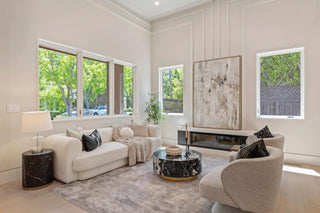 Modern living room , outdoor nature view with white sofa, armchair, and marble coffee table.