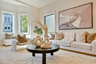 Modern living room with a beige sofa, armchair, and decorative elements stylish tops tree