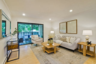 Living room with a couch, chairs, coffee table, and decorative items.