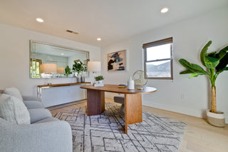 Modern living room with a desk, sofa, and decorative elements.