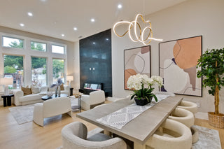 Modern living room with a dining table, chairs, and abstract art on the wall.