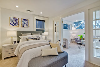 Modern living room with a dining table, chairs, and abstract art on the wall.