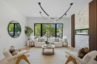 Modern living room with white sofa, armchairs, and decorative elements.