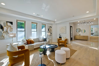 Modern living room with a large window, stylish furniture, and decorative elements.