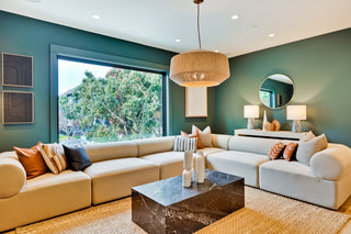 Modern living room with a sectional sofa, coffee table, and decorative elements.