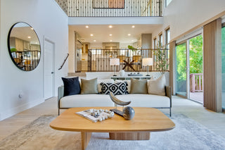 Modern living room with a sofa, coffee table, and decorative items.