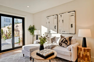 Modern living room with a white sofa, coffee table, and decorative pillows.