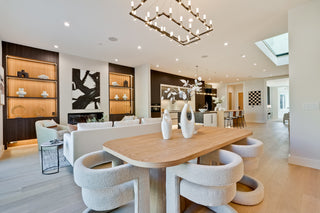 Modern living room with a wooden dining table and white chairs with nice lighting